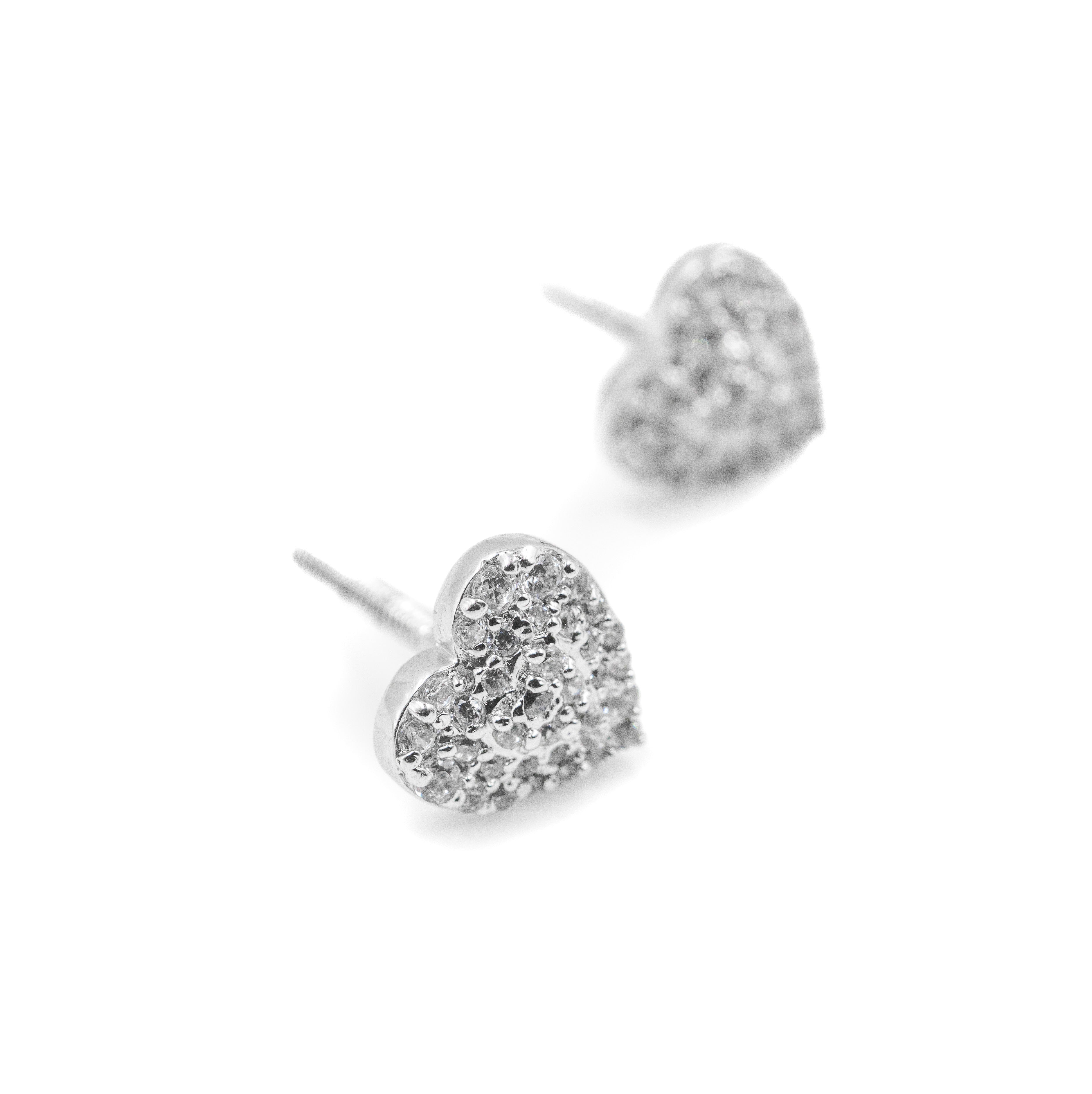 Heart-shaped silver earrings on a white background