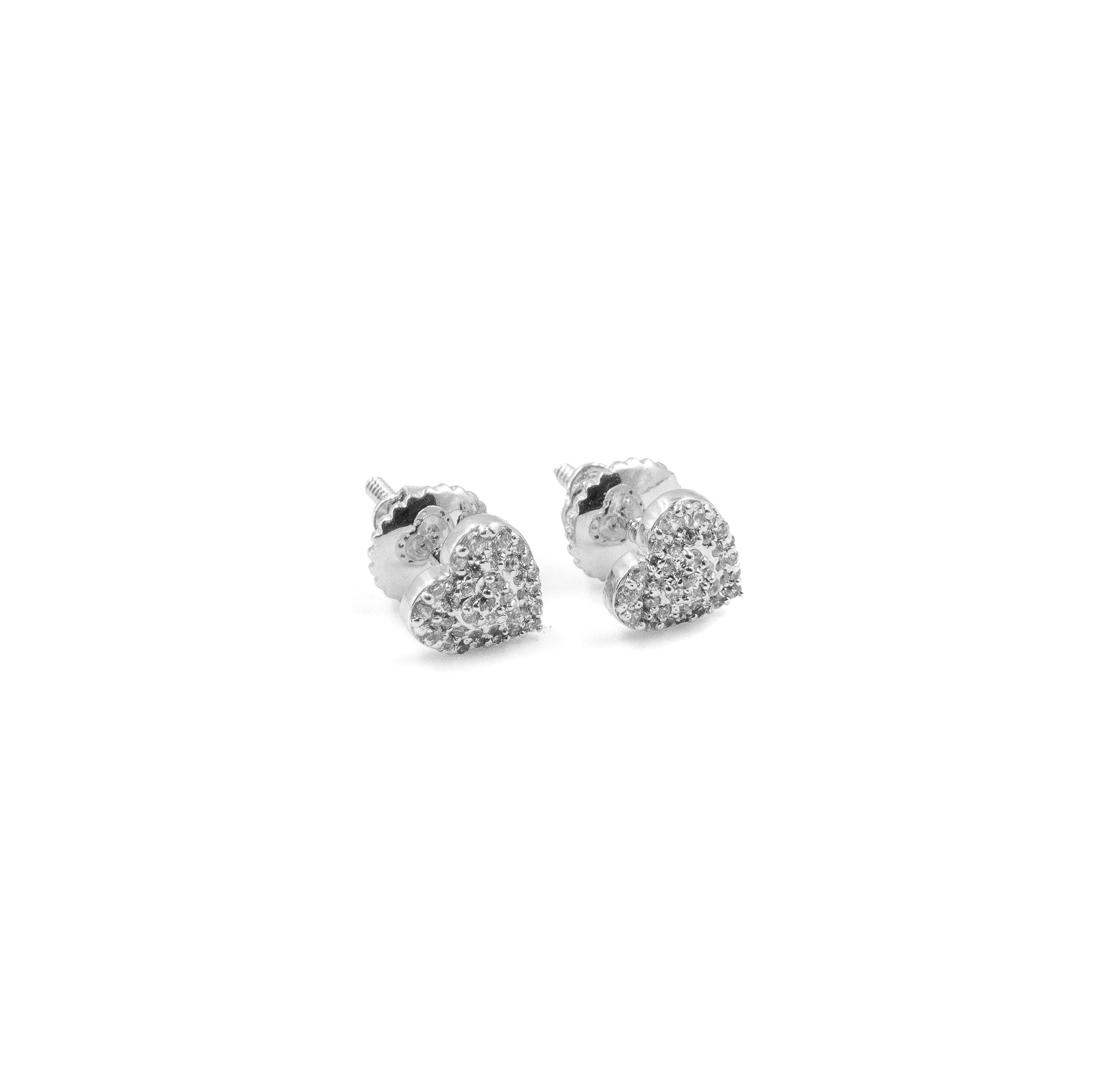 Heart-shaped silver earrings with a glittery finish on a white background